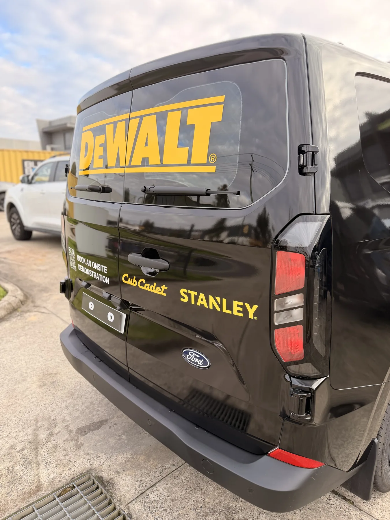 Rear view of a fully wrapped DEWALT commercial van